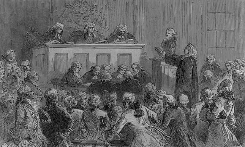 An illustration of several men in a courtroom. One man is standing with his hand outstretched, facing the judge.