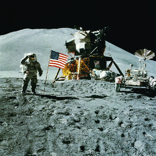 A photo of an astronaut on the moon standing next to the American flag.