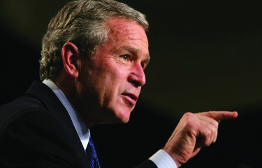 An image of George W. Bush in profile, pointing his finger to the right.