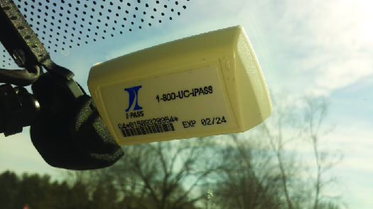 A photo of an E-Z Pass attached to the inside of a car windshield.